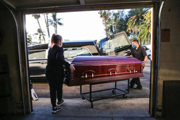 Workers load the casket into a hearse at East County Mortuary in El Cajon, Calif., on Jan. 15, 2021. (Mario Tama/Getty Images)