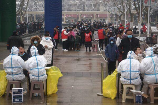 Residents queue to receive COVID-19 coronavirus tests as part of a mass testing program in Zhengzhou, in China's central Henan Province, on Jan. 5, 2022. (STR/CNS/AFP via Getty Images)