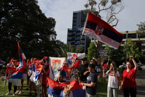 Supporters of Serbian tennis player Novak Djokovic rally outside the Park Hotel, where the star athlete is believed to be held while he stays in Melbourne, Australia, on Jan. 6, 2022. (Loren Elliott/Reuters)