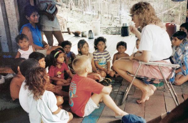 Elizabeth Warner talks with children who live on the Amazon River. (Courtesy of David Warner)