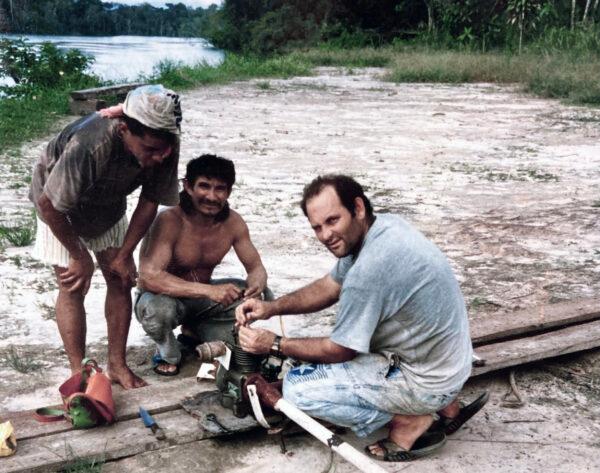 Volunteer David Warner helps locals fix a canoe motor on the Amazon River. Some of his mechanical skills were learned in the U.S. Navy as a petty officer aboard the aircraft carrier USS Independence (CV-62) in the 1970s. (Courtesy of David Warner)