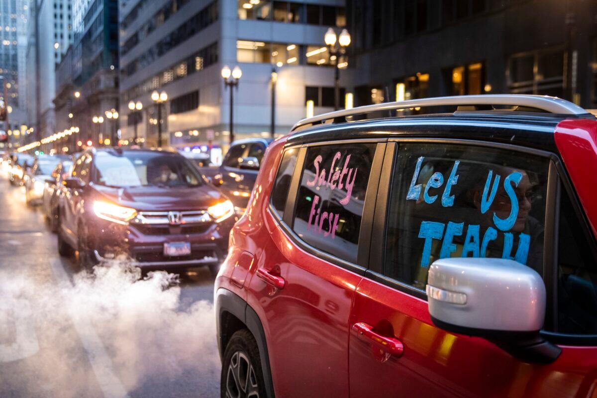 Members of the Chicago Teachers Union and supporters stage a car caravan protest outside City Hall in the Loop in Chicago, Ill., on Jan. 5, 2022. (Ashlee Rezin /Chicago Sun-Times via AP)