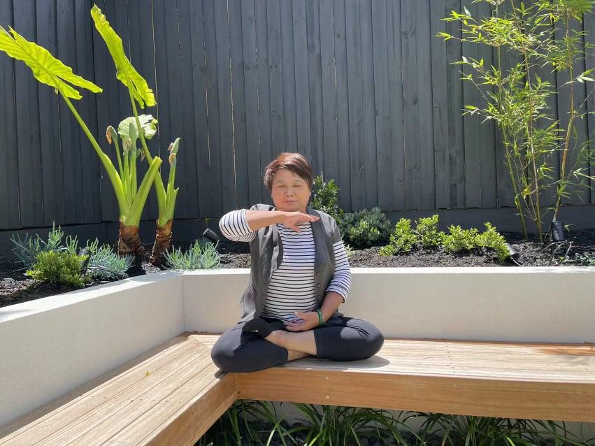 Zhang Cuiying, 59, practicing the fifth meditative exercise of Falun Gong at her home in Australia.