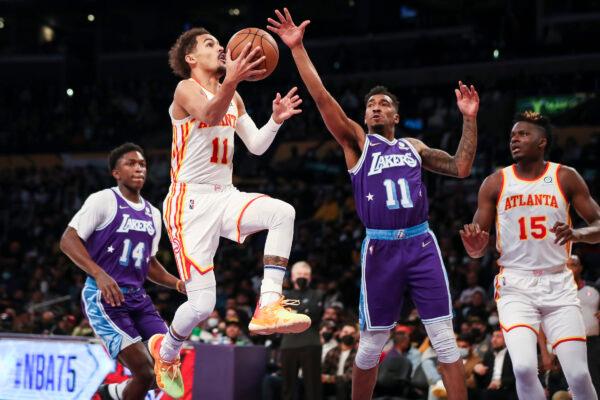 Trae Young #11 of the Atlanta Hawks drives to the basket defended by Malik Monk #11 of the Los Angeles Lakers in the first half at Crypto.com Arena, in Los Angeles, on Jan. 7, 2022. (Meg Oliphant/Getty Images)
