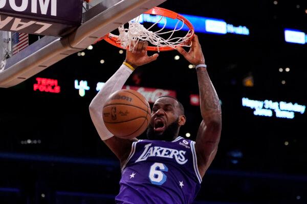 Los Angeles Lakers forward LeBron James (6) dunks the ball during the first half of an NBA basketball game against the Atlanta Hawks in Los Angeles, Jan. 7, 2022. (Ashley Landis/AP Photo)