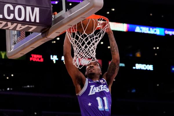 Los Angeles Lakers guard Malik Monk (11) dunks the ball during the first half of an NBA basketball game against the Atlanta Hawks in Los Angeles, Jan. 7, 2022. (Ashley Landis/AP Photo)