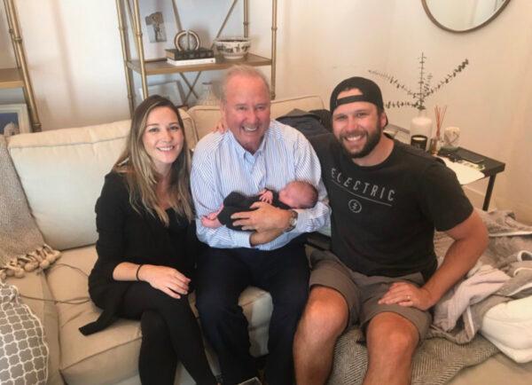 Stephen Judge (C) meets his granddaughter Keira during a 2019 visit with the newborn's parents, Brendan and Jenny Judge. (Courtesy of the Judge family)