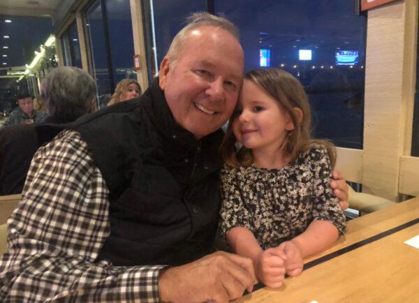 Stephen Judge and his 4-year-old granddaughter, Remi, share secrets during a visit just before he fell ill with COVID-19. (Courtesy of Caitlin Judge)
