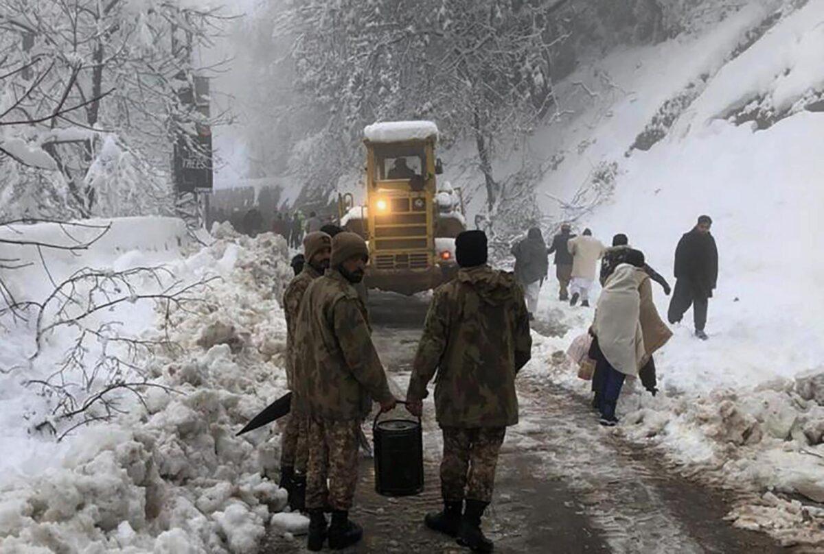 In this photo provided by the Inter-Services Public Relations, army members take part in a rescue operation in a heavy snowfall-hit area in Murree, Pakistan on Jan. 8, 2022. (Inter-Services Public Relations via AP)