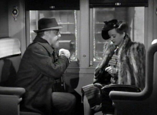Snobby Sheridan Whiteside (Monty Woolley) and his secretary Maggie Cutler (Bette Davis) ride a train into town, in “The Man Who Came to Dinner.” (Warner Bros.)