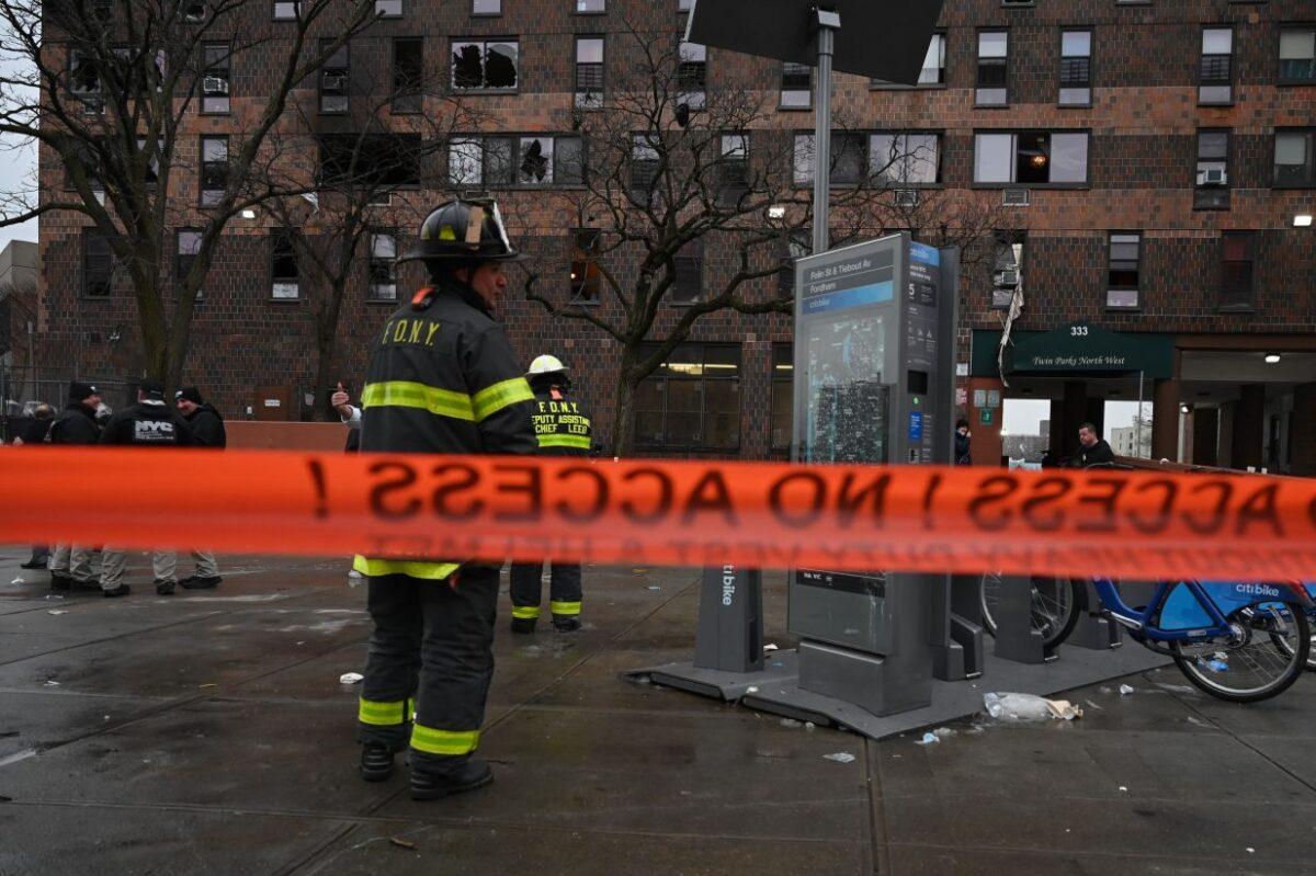 Firefighters work outside an apartment building after a fire in the Bronx, on Jan. 9, 2022, in New York. (Ed Jones/AFP via Getty Images)