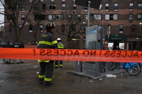 Firefighters work outside an apartment building after a fire in the Bronx, New York, on Jan. 9, 2022. (Ed Jones/AFP via Getty Images)