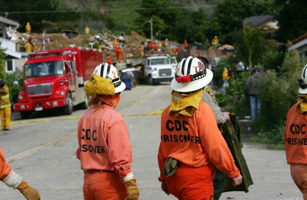 Female prisoners from the California Department of Corrections help in the search for victims of a mudslide that left four people dead and 20 missing in La Conchita, Calif., on Jan. 11, 2005. (David McNew/Getty Images)