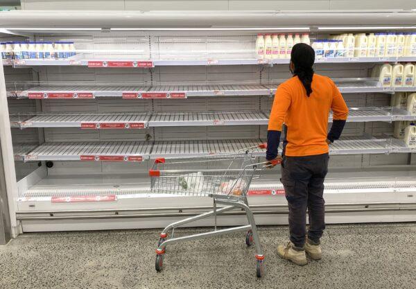 A shopper is seen looking at the empty shelves inside the Coles Supermarket at Kedron in Brisbane, Australia, on Jan. 8, 2021. (AAP Image/Darren England)