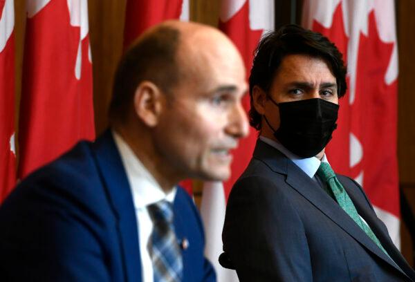 Prime Minister Justin Trudeau listens as Minister of Health Jean-Yves Duclos speaks during a news conference on the COVID-19 pandemic in Ottawa, on Jan. 5, 2022. (The Canadian Press/Justin Tang)