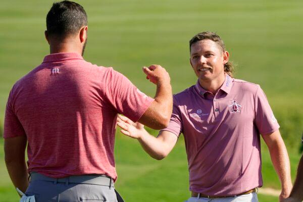 Cameron Smith, right, greets Jon Rahm, of Spain, after Smith won the Tournament of Champions golf event at Kapalua Plantation Course in Kapalua, Hawaii on Jan. 9, 2022. (Matt York/AP Photo)