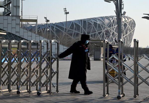 A security guard closes a gate into the Beijing Olympic Park on Jan. 4, 2022, in Beijing. (NOEL CELIS/AFP via Getty Images)