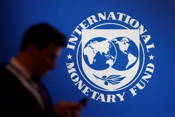 A participant stands near a logo of IMF at the International Monetary Fund—World Bank Annual Meeting 2018 in Nusa Dua, Bali, Indonesia, on Oct. 12, 2018. (Johannes P. Christo/Reuters)
