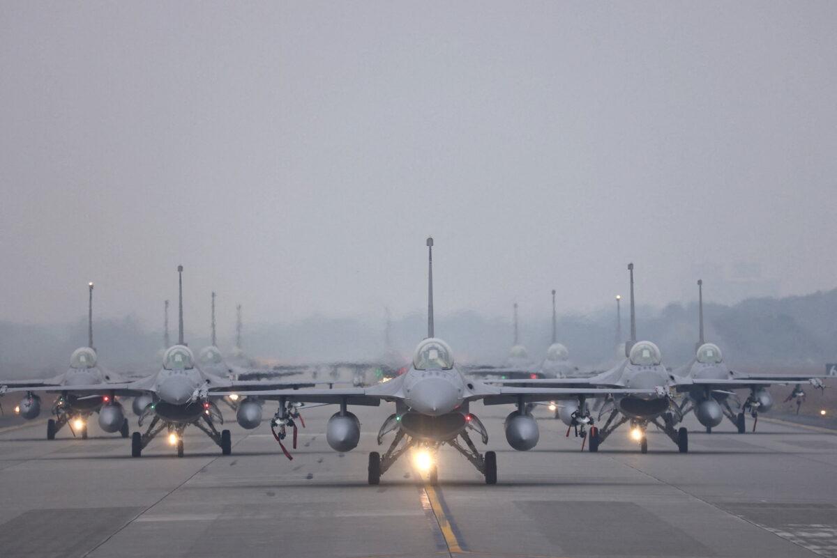 12 F-16V fighter jets perform an elephant walk during an annual New Year's drill in Chiayi, Taiwan, on Jan. 5, 2022. (Ann Wang/Reuters)