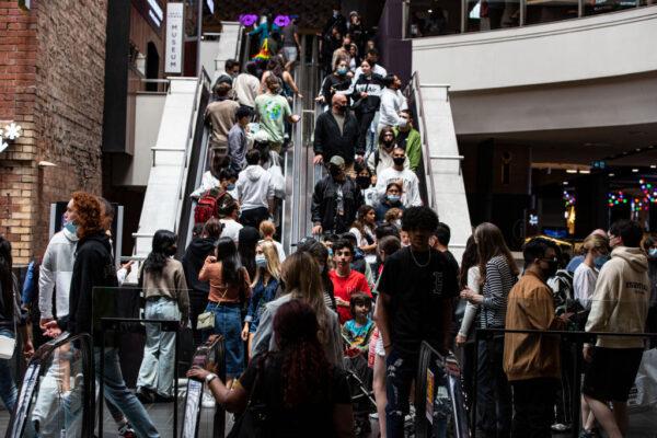 Shoppers ride an escalator at Melbourne Central during the Boxing Day sales in Melbourne, Australia, on Dec. 26, 2021. (Diego Fedele/Getty Images)