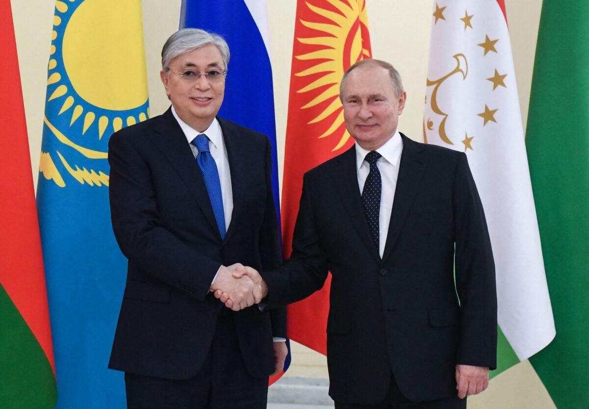 Kazakh President Kassym-Jomart Tokayev greets Russian President Vladimir Putin before the informal annual summit of the Commonwealth of Independent States (CIS) at the presidential residence of Konstantin Palace in Strelna, outside St. Petersburg, Russia, on Dec. 28, 2021. (Yevgeny BiyatovI/AFP via Getty Images)