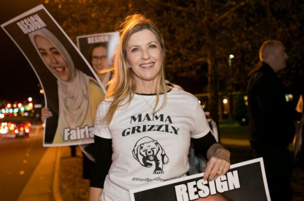 Fairfax County parent Stacy Langton protests outside the Luther Jackson Middle School in Falls Church, Va., before the Fairfax County Public Schools board meeting on Dec. 2, 2021. (Lisa Fan/The Epoch Times)
