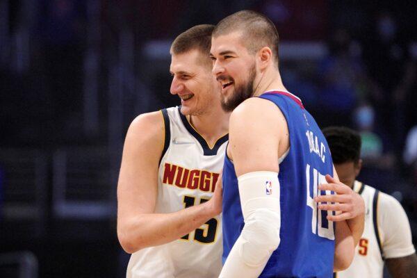 Denver Nuggets center Nikola Jokic, left, and Los Angeles Clippers center Ivica Zubac hug each other prior an NBA basketball game in Los Angeles, on Jan. 11, 2022. (Mark J. Terrill/AP Photo)