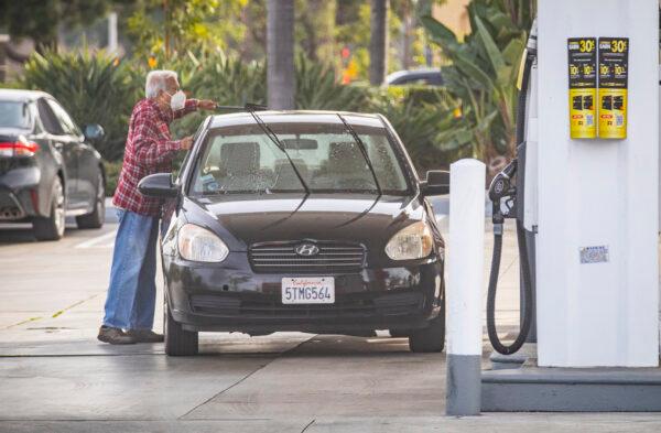 People use gas stations amid high gas prices in Irvine, Calif., on Jan. 12, 2022. (John Fredricks/The Epoch Times)