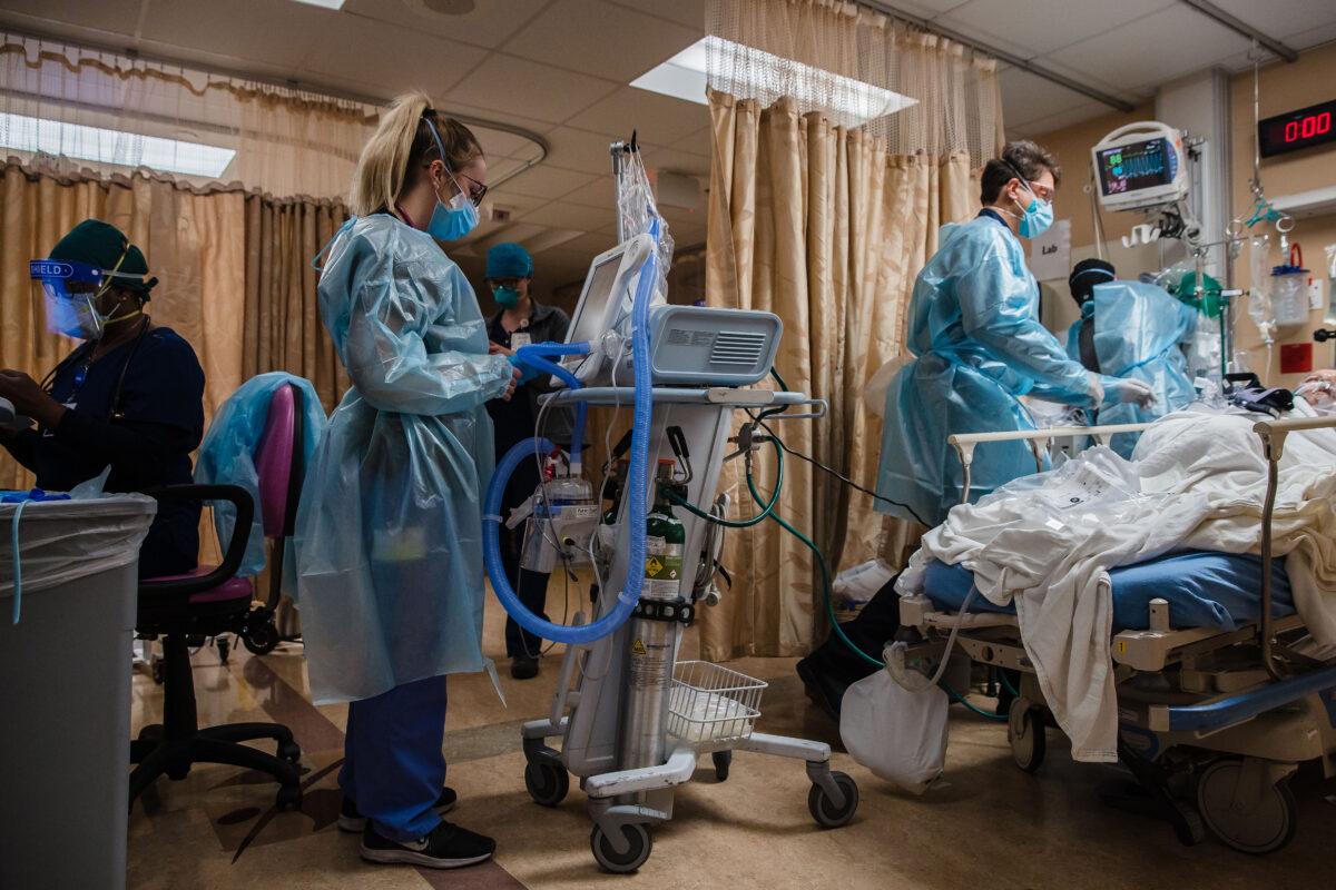 Health care workers tend to a patient in Apple Valley, Califironia, on Jan. 11, 2021. (ARIANA DREHSLER/AFP via Getty Images)
