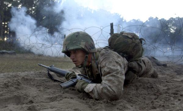 U.S. Marine Corps recruit crawls through simulated combat in boot camp on Parris Island, S.C., on Jan. 15, 2003. (Stephen Morton/Getty Images)