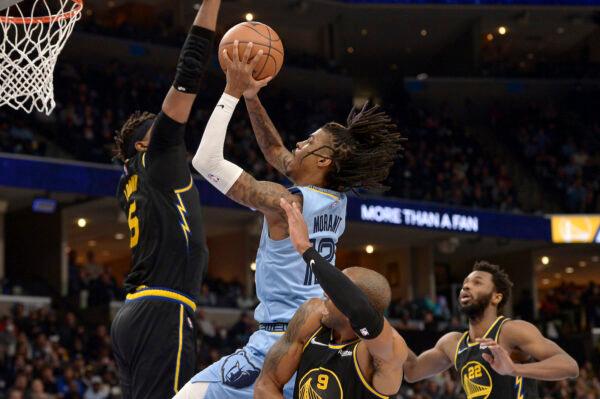 Memphis Grizzlies guard Ja Morant (12) shoots against Golden State Warriors center Kevon Looney (5), and forwards Andre Iguodala (9) and Andrew Wiggins (22) in the second half of an NBA basketball game in Memphis, on Jan. 11, 2022. (Brandon Dill/AP Photo)