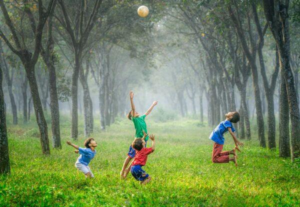 Healthy play with other boys develops positive character traits, encourages healthy competition, and promotes a balanced lifestyle. (Robert Collins/Unsplash)
