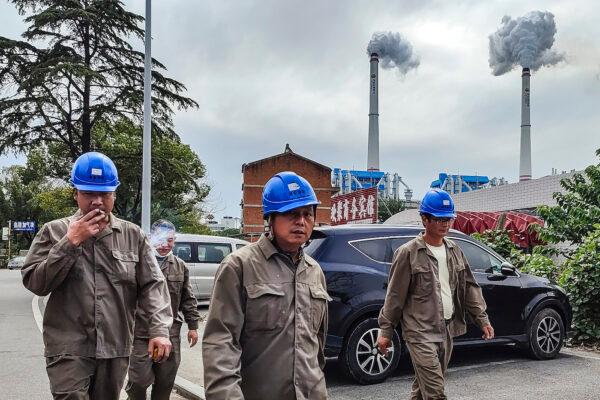 Chinese workers walk past a coal-fired power plant in Hanchuan, Hubei Province on Oct. 13, 2021. (Getty Images)