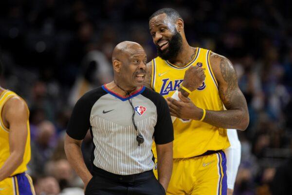 Los Angeles Lakers forward LeBron James, right, works referee Derek Richardson, during a timeout left in the first quarter of an NBA basketball game against the Sacramento Kings in Sacramento, Calif., on Jan. 12, 2022. (José Luis Villegas/AP Photo)