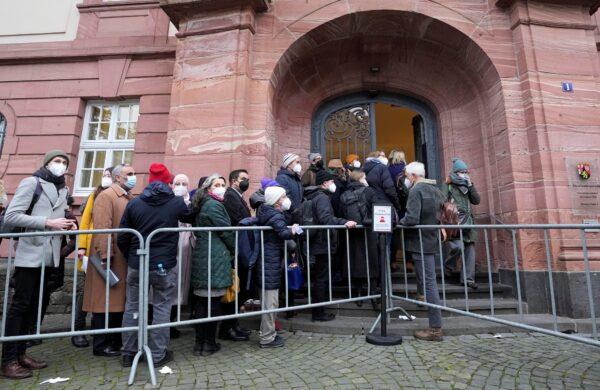People line up in front of the court in Koblenz, Germany, on Jan. 13, 2022. (Martin Meissner/AP Photo)