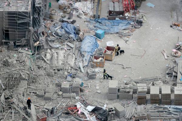 Rescuers search for workers who went missing in an apartment construction accident in Gwangju, South Korea, on Jan. 13, 2022. (Chung Hoe-sung /Yonhap via AP)