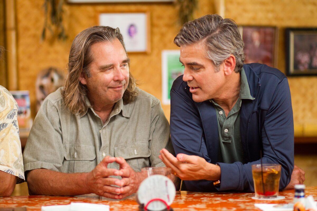 Cousin Hugh (Beau Bridges, L) and Matt King (George Clooney) talk about whether Matt should sell his Hawaiian property so that all his cousins who squandered their inheritances can benefit, in “The Descendants." (FOX Searchlight Pictures)