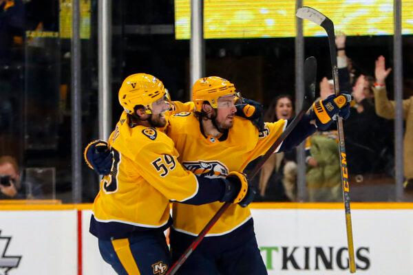 Matt Duchene #95 of the Nashville Predators is congratulated by teammate Roman Josi #59 after scoring the game winning goal in a 5-4 overtime victory over the Colorado Avalanche period at Bridgestone Arena in Nashville, Tenn., on Jan. 11, 2022. (Frederick Breedon/Getty Images)