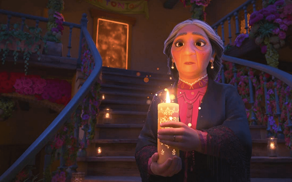 Abuela Alma (voiced by María Cecilia Botero), the grand matriarch of the village of Encanto, welcomes guests to observe the bestowing of a new superpower, in "Encanto." (Walt Disney Animation Studios)
