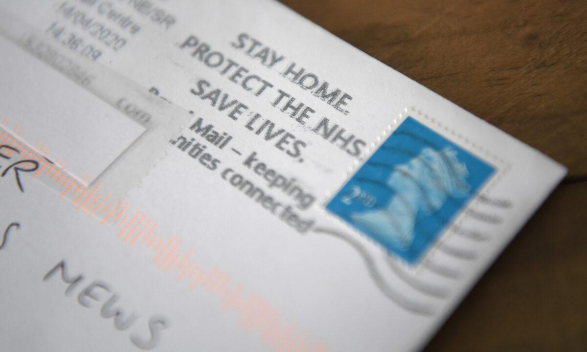 A stay home, protect the NHS, saves lives message is seen on a postmark on a stamped envelope in Penarth, Wales on April 16, 2020. (Stu Forster/Getty Images)