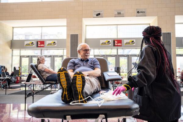 A phlebotomist tends to a blood donor during the Starts, Stripes, and Pints blood drive event in Louisville, Kentucky on July 7, 2021. (Jon Cherry/Getty Images)