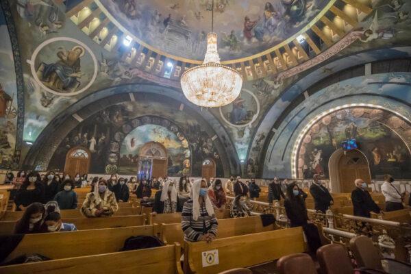 Believers pray during the Christmas mass at the Archangel Michael Coptic Orthodox Church in Cairo, Egypt, on Jan. 6, 2022. (Khaled Desouki/AFP via Getty Images)