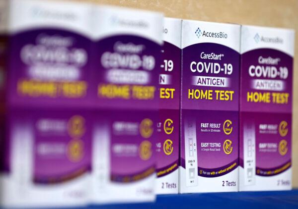 COVID-19 rapid at-home test kits rest on a table at a free distribution event for those who received vaccination shots or booster shots, at Union Station, in Los Angeles, Calif., on Jan. 7, 2022. (Mario Tama/Getty Images)