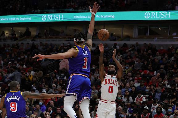 Coby White #0 of the Chicago Bulls shoots over Damion Lee #1 of the Golden State Warriors during the first half of a game at United Center in Chicago on Jan. 14, 2022. (Stacy Revere/Getty Images)
