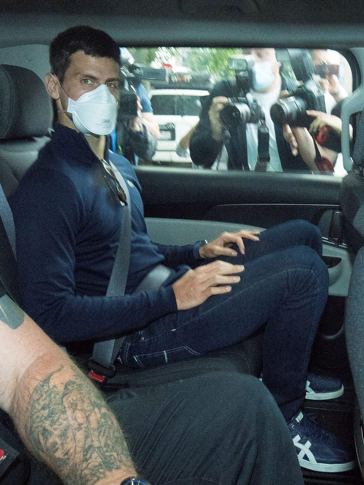 Serbian tennis player Novak Djokovic rides in car as he leaves a government detention facility before attending a court hearing at his lawyers office in Melbourne, Australia, on Jan. 16, 2022. (James Ross/AAP via AP)