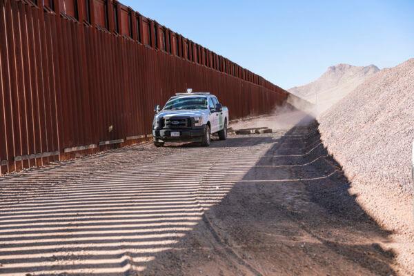 A Border Patrol agent pulls tires behind his vehicle to smooth out the road to make detecting footprints easier, near Naco in Cochise County, Ariz., on Dec. 6, 2021. (Charlotte Cuthbertson/The Epoch Times)