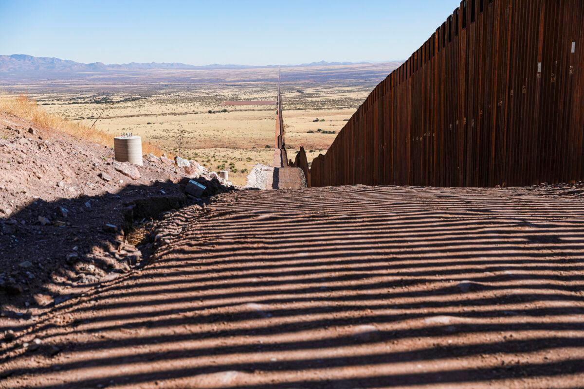 The border wall’s accompanying road, lights, cameras, and sensors remain unfinished since January 2021 when President Joe Biden halted all border wall construction, in Cochise County, Arizona on Dec. 6, 2021. (Charlotte Cuthbertson/The Epoch Times)