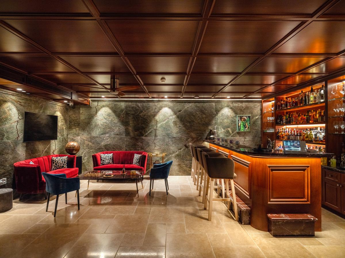 The wine cellar and lounge bar is a transportive affair with an ambiance that reminds one of a classy London or Paris private club, only right at home. (Courtesy of Sotheby's International Realty - Greece)