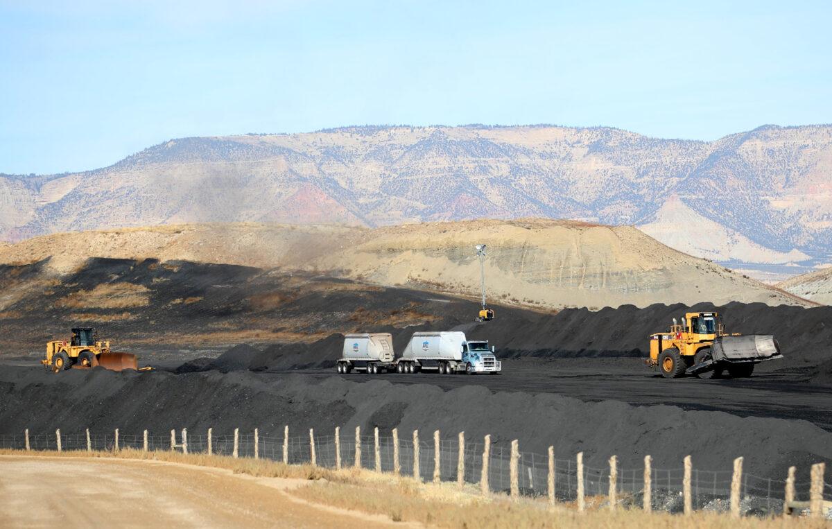 A truck delivers coal as heavy equipment moves coal into piles at PacifiCorp's Hunter coal fired power pant outside of Castle Dale, Utah on Nov. 14, 2019. (GEORGE FREY/AFP via Getty Images)