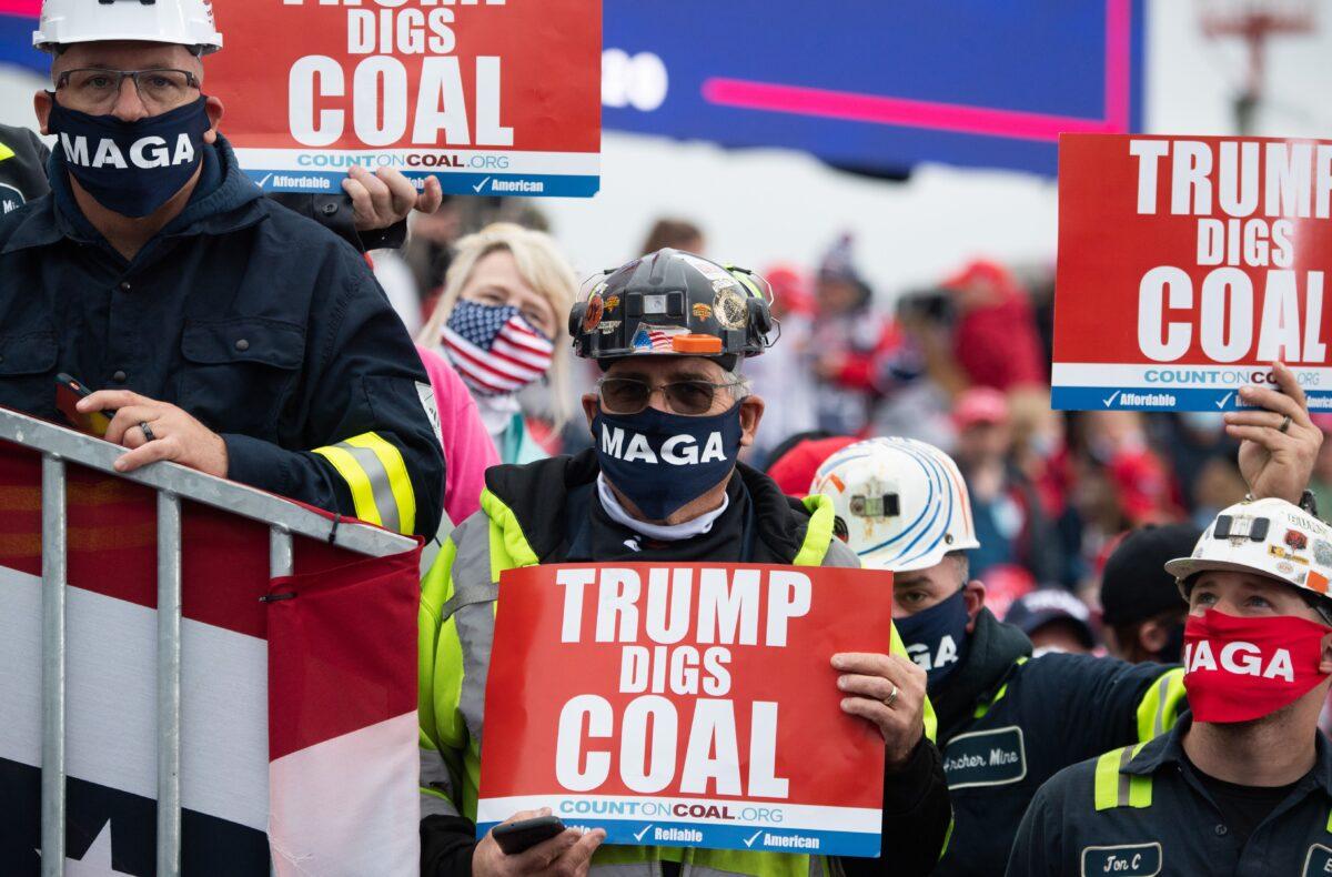 Supporters holds signs in favor of coal mining as then-President Donald Trump speaks during a Make America Great Again campaign rally at Altoona-Blair County Airport in Martinsburg, Pennsylvania, on Oct. 26, 2020. (SAUL LOEB/AFP via Getty Images)